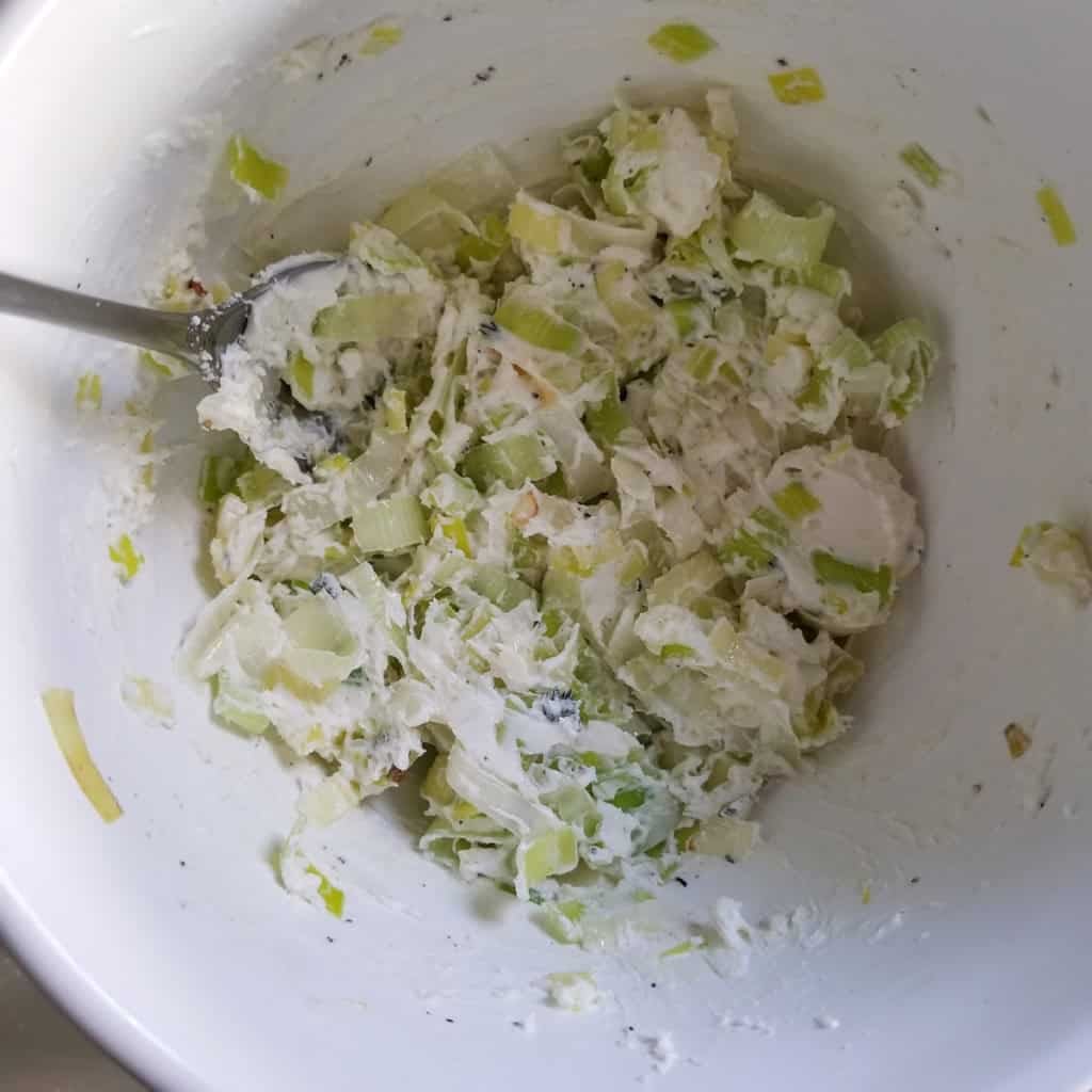 Pork Tenderloin Stuffed with Goat Cheese, Leeks and Prosciutto - Goat cheese and leeks in a bowl